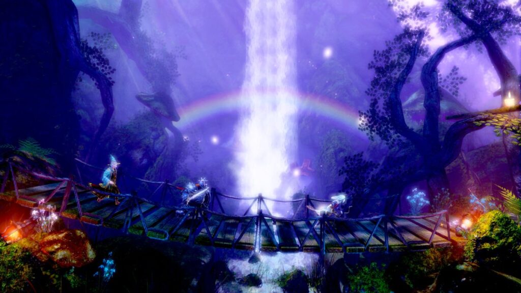 The Trine party cross a bridge passing a waterfall