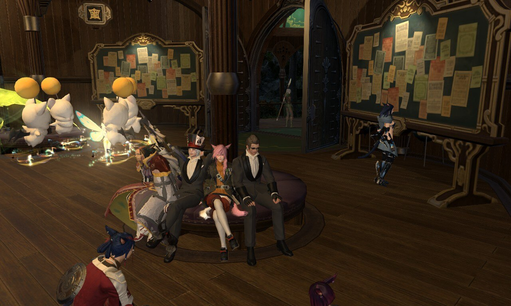 A group of friends sitting around a bench in Final Fantasy XIV